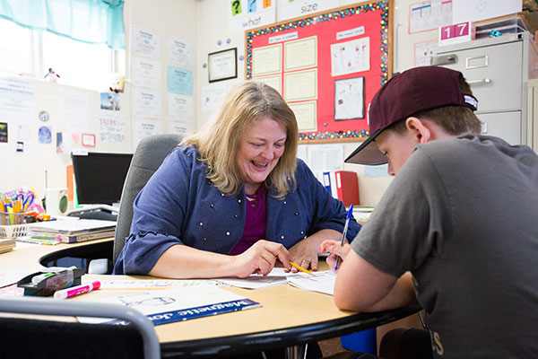 Teacher helping student with assignment